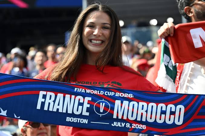 A Morocco supporter holds a France vs Morocco scarf at the 2026 World Cup quarter-final in Boston — the Atlas Lions face the defending champions